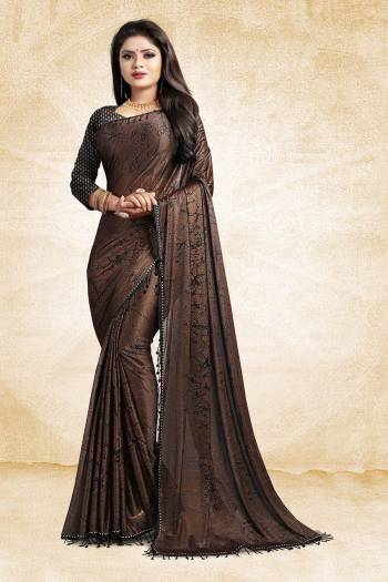 For A Bold And Beautiful Look, Grab This Designer Fancy China Fabricated Saree In Brown Color Paired With Black Colored Blouse. It Is Beautified With Prints And Lace Border, Buy This Designer Saree Now.