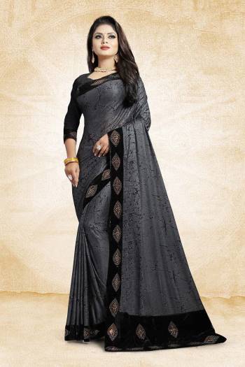 Flaunt Your Rich And Elegant Taste Wearing This Designer Saree In Grey Color Paired With Black Colored Blouse, This Saree And Blouse Are Fabricated On Fancy China Fabrics Which Is Light Weight And Easy To Carry Throughout The Gala.