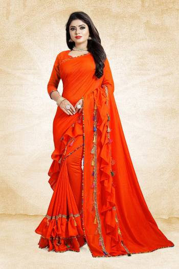 Catch All The Limelight At The Next Wedding You Attend With This Designer Saree In Orange Color Paired With Orange Colored Blouse. This Saree And Blouse are Silk Based Beautified With Fancy Laces And Frill Border. 