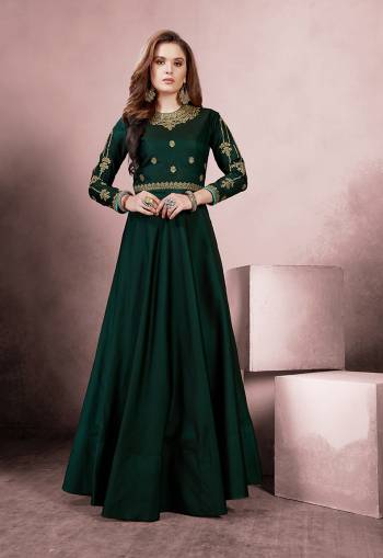 Get Ready For The Upcoming Festive And Wedding Season With This Designer Readymade Gown In Pine Green Color Fabricated On Tafeta Silk Beautified With Attractive Embroidery Over The Yoke And Sleeves. Buy Now.