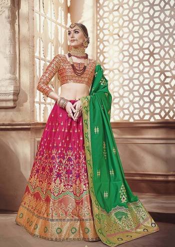 Celebrate This Festive Season with Beauty And Comfort Wearing this Designer Silk Based Lehenga Choli In Multi Colored Blouse Paired With Dark Pink Colored Lehenga And Green Colored Dupatta. It Is Beautified With Weave All Over.