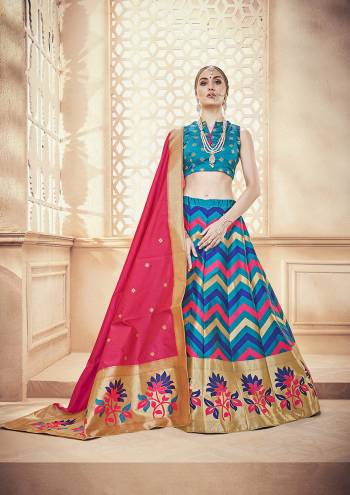 Here Is A Very Pretty Designer Lehenga Choli In Blue Color Paired With Contrasting Dark Pink Colored Dupatta. This Whole Lehenga Choli And Dupatta Are Fabricated On Banarasi Art Silk Beautified With Weave. 