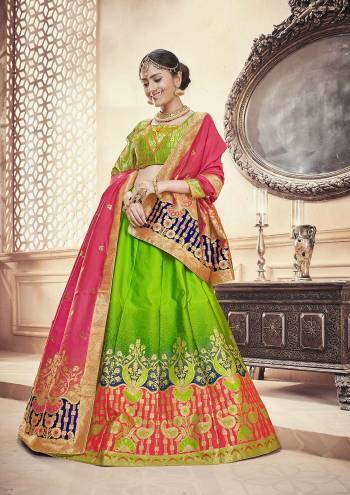 Attract All In This Designer Silk Based Lehenga Choli In Parrot Green Color Paired With Contrasting Dark Pink Colored Dupatta. This Lehenga Choli And Dupatta Are Fabricated On Banarasi Art Silk Beautified With Weave. Buy Now.