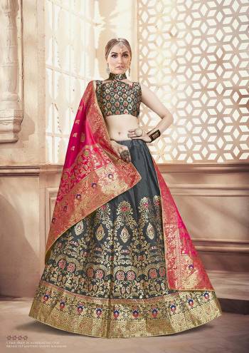 Flaunt Your Rich And Elegant Taste Wearing This Designer Lehenga Choli In Grey Color Paired With Contrasting Dark Pink Colored Dupatta. This Lehenga Choli And Dupatta Are Fabricated On Banarasi Art Silk Beautified With Weave. 