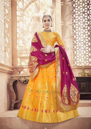 Catch All The Limelight At The Next Function You Attend With This Designer Lehenga Choli In Yellow Color Paired With Contrasting Magenta Pink Colored Dupatta. This Whole Attire Is Fabricated On Banarasi Art Silk Beautified With Attractive Weave All Over. 