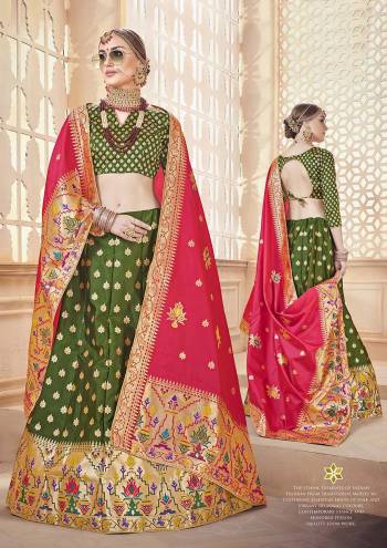 For A Proper Traditional Look, Grab This Designer Lehenga Choli In Green Color Paired With Contrasting Dark Pink Colored Dupatta. It Is Fabricated On Banarasi Art Silk Beautified With Attractive Weave. 