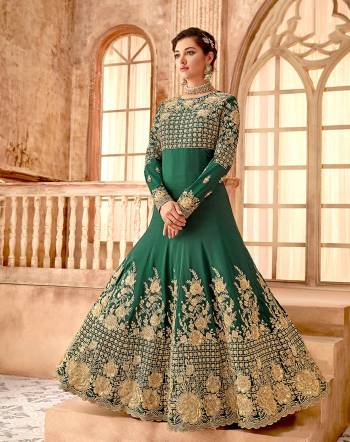 Here Is A Very Pretty Designer Floor Length Suit In Pine Green Color Paired With Pine Green Colored Bottom And Matching Dupatta. Its Top Is Fabricated On Satin Silk Beautified With Heavy Embroidery Paired With Santoon Bottom And Chiffon Fabricated Dupatta. 