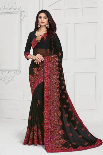 Get Ready For The Upcoming Festive And Wedding Season With This Heavy Deisgner Saree In Black Color Paired With Black Colored Blouse. This Saree And Blouse Are Fabricated On Georgette Beautified With Heavy Resham And Stone Work With Contrasting Thread Colors.