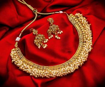 Grab This Heavy Necklace Set For The Upcoming Wedding Season. Pair This Up With Your Heavy Ethnic Attire And As It Is In Golden Color, It Can Be Paired With Any Colored Attire. Buy Now