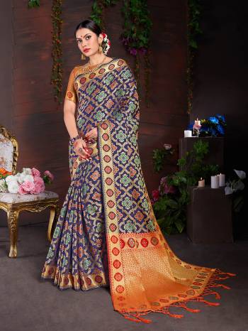 Enhance Your Personality Wearing This Designer Silk Based Saree In Navy Blue Color Paired With Contrasting Orange Colored Blouse. This Saree And Blouse Are Fabricated On Lichi Art Silk Beautified With Weave All Over. 