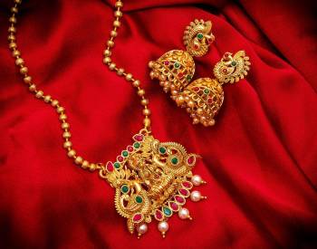 Give An Enhanced Look To Your Personality By Pairing Up This Beautiful Pendant Set With Your Ethnic Attire. This Pretty Set Is In Golden Color Beautified With Multi Colored Stone And Pearl Work. Buy Now.