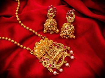 Give An Enhanced Look To Your Personality By Pairing Up This Beautiful Pendant Set With Your Ethnic Attire. This Pretty Set Is In Golden Color Beautified With Multi Colored Stone And Pearl Work. Buy Now.