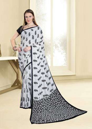 Simple And Elegant Looking Saree For Your Casual Wear Is Here In White And Black Color Paired With Black Colored Blouse. This Saree And Blouse are Fabricated On Crepe Beautified With Prints All Over. 