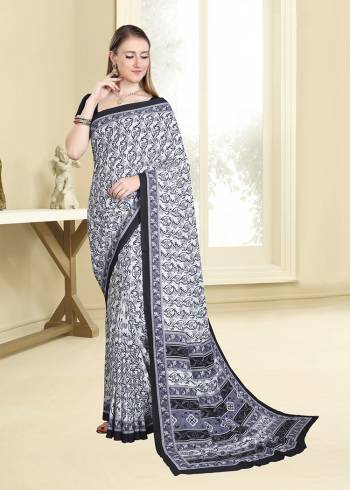 Simple And Elegant Looking Saree For Your Casual Wear Is Here In White And Black Color Paired With Black Colored Blouse. This Saree And Blouse are Fabricated On Crepe Beautified With Prints All Over. 