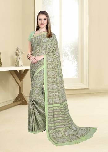 Here Is A Very Pretty Printed Saree In Light Green and Grey Color Paired With Light Green Colored Blouse. This Saree And Blouse Are Fabricated On Crepe Beautified With Intricate Prints All Over It. 