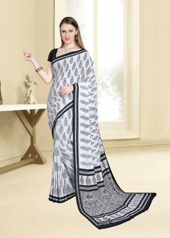 Simple And Elegant Looking Saree For Your Casual Wear Is Here In White And Black Color Paired With Black Colored Blouse. This Saree And Blouse are Fabricated On Crepe Beautified With Prints All Over. 