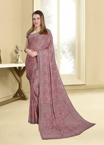 Look Pretty In This Rich Dusty Pink Colored Saree Paired With Dusty Pink Colored Blouse. This Saree And Blouse Are Fabricated On Crepe Beautified With Pretty Prints All Over It. 