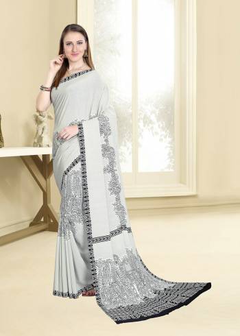 Simple And Elegant Looking Saree For Your Casual Wear Is Here In White Color Paired With Black Colored Blouse. This Saree And Blouse are Fabricated On Crepe Beautified With Prints All Over. 