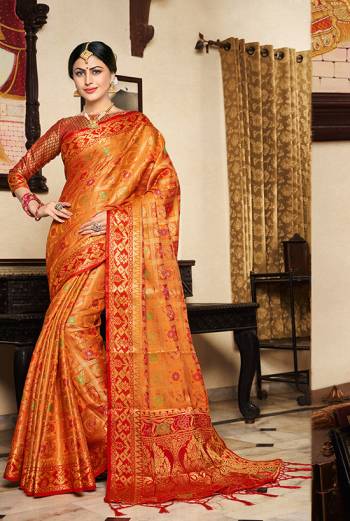 Here A Proper Traditional Color Pallete With This Designer Saree In Orange Color Paired With Contrasting Red Colored Blouse. This Saree And Blouse Are Fabricated On Lichi Art Silk Beautified With Weave All Over. Buy Now.