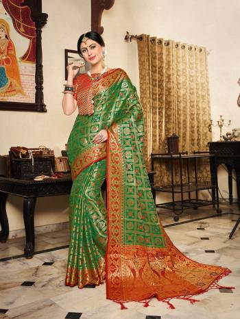 Here A Proper Traditional Color Pallete With This Designer Saree In Green Color Paired With Contrasting Red Colored Blouse. This Saree And Blouse Are Fabricated On Lichi Art Silk Beautified With Weave All Over. Buy Now.