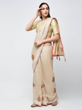 Flaunt Your Rich And Elegant Taste Wearing This Designer Silk Based Saree In Cream Color Paired With Cream Colored Blouse. It Is Beautified With Weave And Butti Embroidery. 