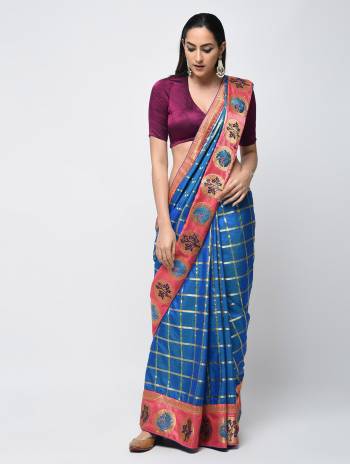 Celebrate This Festive Season With Beauty And Comfort Wearing This Designer Silk Based Saree In Blue Color Paired With Contrasting Wine Colored Blouse. It Is Beautified With Embroidered Lace Border And Weaved Checks All Over. 