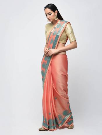 Look Pretty In This Designer Silk Based Saree In Peach Color Paired With Contrasting Cream Colored Blouse. It Is Beautified With Contrasting Embroidery And Lace Border. 