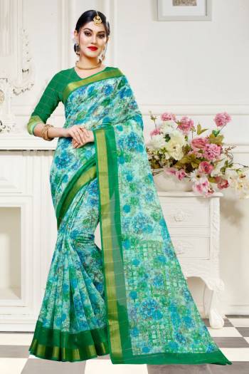 For Your Work Place And Comfort, Grab This Printed Saree In Sky Blue Color Paired With Green Colored Blouse. This Saree And Blouse are Fabricated On Cotton Silk Beautified With Floral Prints All Over It. Buy This Saree Now.