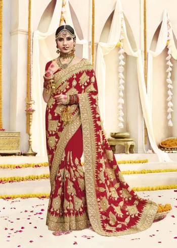 Here Is Beautiful Collection In Bridal Sarees With This Designer Saree In Red Color Paired With Red Colored Blouse. This Saree And Blouse are fabricated On Georgette Beautified With Heavy Jari Embroidery And Stone Work. This Beautiful Heavy Saree Will A Proper Bridal Look And Will Earn You Lots Of Compliments From Onlookers.