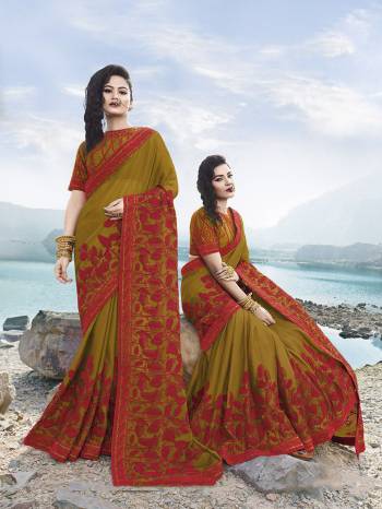 Another New And Attractive Shade Is Here With This Heavy Designer Saree In Pear Green Color Paired With Pear Green Colored Blouse. This Saree Is Fabricated On Satin Georgette Paired With Art Silk Fabricated Blouse, It Is Beautified With Contrasting Red Colored Embroidery All Over. 
