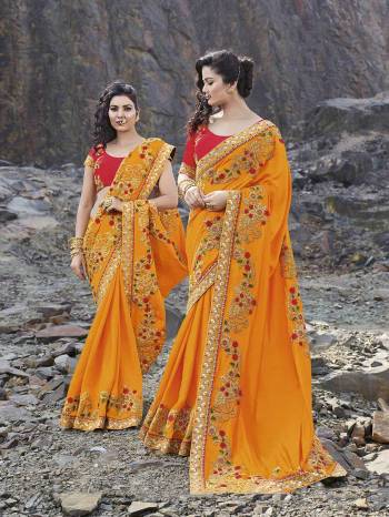 Celebrate This Festive Season Wearing This Heavy Designer Saree In Musturd Yellow Color Paired With Contrasting Red Colored Blouse. This Saree IS Fabricated On Silk Georgette Paired With Art Silk Fabricated Blouse. Buy This Saree Now.