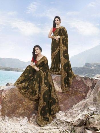 A Must Have Shade In Every Womens Wardrobe Is Here With This Heavy Designer Saree In Dark Green Color Paired With Red Colored Blouse. This Saree Is Art Silk Based Paired With Art Silk Fabrricated Blouse. It Is Beautified With Jari Work Giving A Subtle Look To The Saree. 