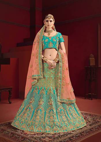 Go With Seasons Trending Heavy Designer Lehenga Choli In Blue Color Paired With Contrasting Peach Colored Dupatta. Its Heavy Embroidered Blouse And lehenga Are Fabricated On Satin Paired With Heavy Embroidered Net Fabricated Dupatta. Its Pretty Color Pallete And Heavy Embroidery Is Making The Lehenga More Attractive. 