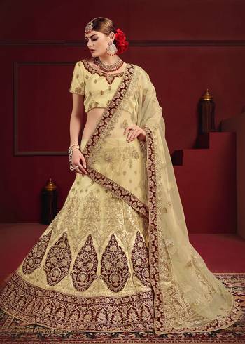 Evergreen And Rich Combination Is Here With This Heavy designer Lehenga Choli In All Cream Color Highlighted With Maroon Colored Patch Work And Lace Borders. Its Blouse And Lehenga Are Satin Based Paired With Net Fabricated Dupatta. It Is Beautified With Heavy Embroidery And Suitable For A Bridal Look.