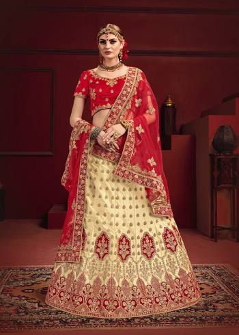 Get Ready For Your D-Day With This Heavy designer Bridal Lehenga Choli. Its Blouse And Dupatta Are In Red Color Paired With Cream Colored Lehenga. This Heavy Embroidered Lehenga Choli Is Satin Based Paired With Net Fabricated Dupatta. Buy This Lovely Piece Now.