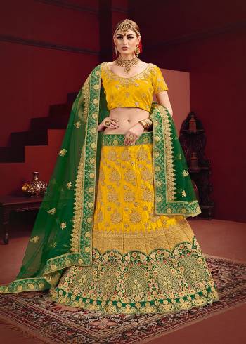 Add This Beautiful And Attractive Heavy Designer Lehenga Choli To Your Wardrobe For The Upcoming Festive And Wedding Season. This Beautiful Lehenga Choli Is In Attractive Yellow Color Paired With Contrasting Green Colored Dupatta. This lehenga Choli IS Satin Based Paired With Net Fabricated Dupatta. It Is Beautified With Heavy Jari And Thread Embroidery With Stone Work. 