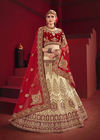 Get Ready For Your D-Day With This Heavy designer Bridal Lehenga Choli. Its Blouse And Dupatta Are In Red Color Paired With Cream Colored Lehenga. This Heavy Embroidered Lehenga Choli Is Satin Based Paired With Net Fabricated Dupatta. Buy This Lovely Piece Now.