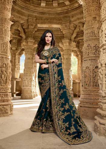 New And Trendy Shade Is Here To Add Into Your Wardrobe With This Heavy Designer Saree In Prussian Bue Color Paired With Contrasting Olive Green Colored Blouse. This Saree And Blouse are Silk Based Which Also Gives A Rich Look To Your Personality. 