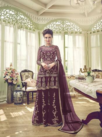 New Shade Is Here To Add Into Your Wardrobe With This Designer Semi-Stitched Suit In Wine Color. Its Top, Bottom And Dupatta Are Fabricated On Net Beautified With Heavy Embroidery. 