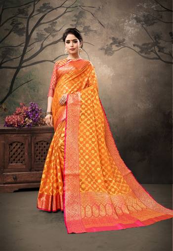 Celebrate This Festive Season With Traditional Color Pallete And Rich Silk with This Saree In Orange Color Paired With Contrasting Dark Pink Colored Blouse. This Saree And Blouse are Fabricated On Banarasi Art Silk Beautified With Weave All Over. 