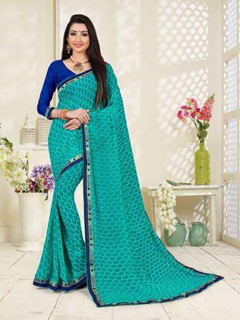 Go With The Pretty Shades Of Blue With This Printed Saree In Sky Blue Color Paired With Royal Blue Colored Blouse. This Saree And Blouse Georgette bAsed Beautified With prints.