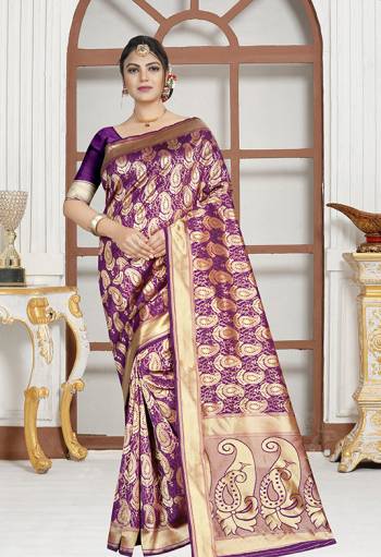 Here Is A Very Pretty Designer Saree In Purple Color Paired With Purple Colored Blouse. This Saree And Blouse are Silk Based Beautified With Paisly Weave All Over It. Buy This Saree Now.