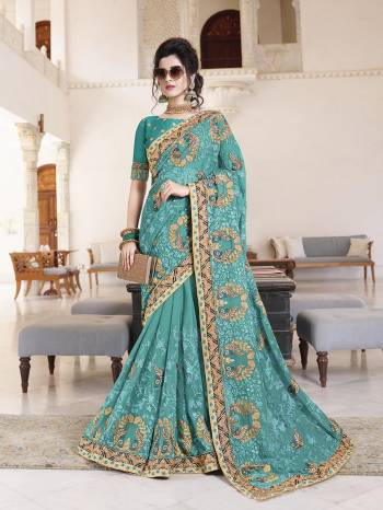 Flaunt Your Rich And Elegant Taste Wearing This Heavy Designer Saree With Tone To Tone Embroidery In Turquoise Blue Color Paired With Turquoise Blue Colored Blouse. This Pretty Saree Is Georgette Based Paired With Art Silk Fabricated Blouse. 