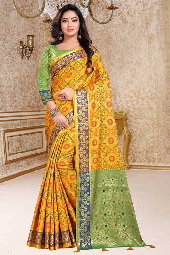 Enhance Your Personality In This Very Beautiful Heavy Weaved Silk Based Saree In Yellow Color Paired With Contrasting Light Green Colored Blouse. This Saree And Blouse Are Fabricated On Patola Art Silk Beautified With Heavy Intricate Weave All Over. Buy This Saree Now.