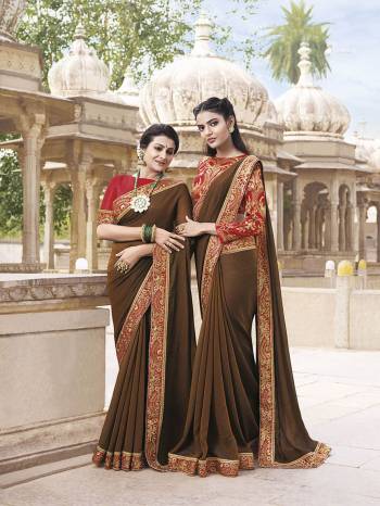 Enhance Your Personality Wearing This Designer Saree In Brown Color Paired With Contrasting Red Colored Blouse. This Saree Is Fabricated On Chiffon Paired With Art Silk Fabricated Blouse. It Is Light Weight And Easy To Carry Throughout The Gala. 