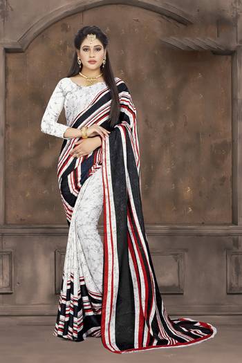 Simple Saree For Your Casual Wear Is Here In White And Black Color Paired With White Colored Blouse. This Saree And Blouse are Fabricated On Crepe Jacquard Beautified With Prints. Grab this Light Weight Saree For Casuals Now.