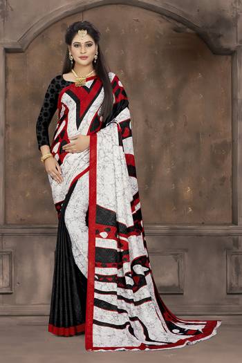 Add Some Casuals To Your Wardrobe With This Printed Saree In White And Black Color Paired With Black Colored Blouse. This Saree And Blouse Are Fabricated On Crepe Jacquard Beautified With Prints. 