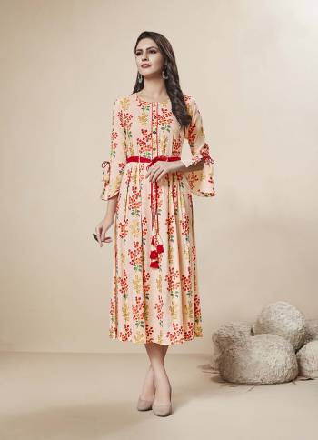 Pretty In Peach, A Must Have Shade In Every Womens Wardrobe Is Here With This Readymade Kurti In Light Peach Color Fabricated On Rayon. It Is Beautified With Floral Prints And Foil Print All Over It.