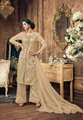 Flaunt Your Rich And Elegant Taste With This Designer Straight Suit In Cream Color. This Pretty Suit Is Net Based Paired With Embroidered Satin Based bottom and Net Fabricated Dupatta. Its Top Is Beautified With Heavy Embroidery And Same Colored Pearl Work.