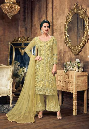 Grab This Heavy Embroidered Designer Straight Suit In Very Pretty And Unique Shade In Light Green Color. Its Top And Dupatta Are Fabricated On Net Paired With Satin Silk Fabricated Bottom. It Is Beautified With Embroidered Over And Bottom both. 